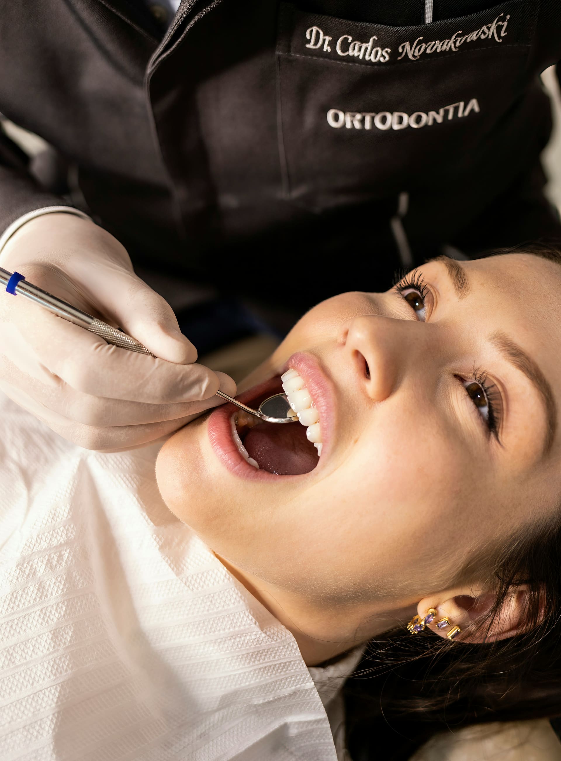 Dentist performing a gentle check-up on a smiling patient