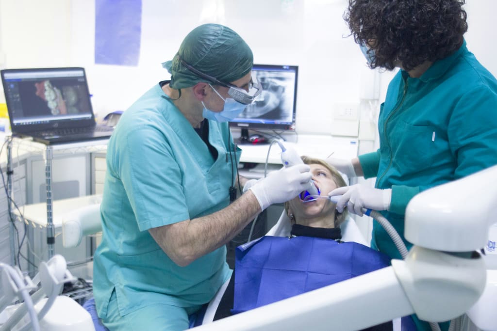 Dental team treating a patient in the clinic